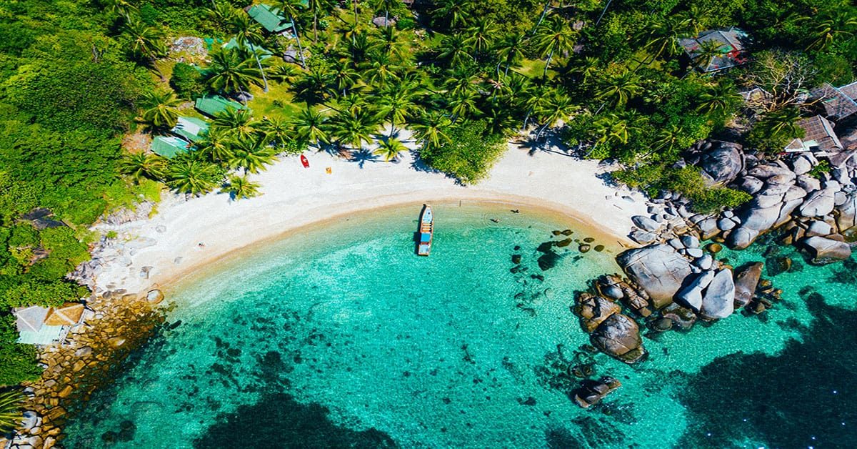 Top-down view on one of the beautiful white sand beaches with turquoise water in Phuket.